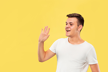 Image showing Caucasian young man\'s half-length portrait on yellow background