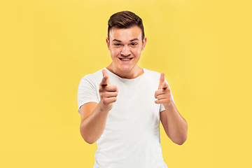 Image showing Caucasian young man\'s half-length portrait on yellow background