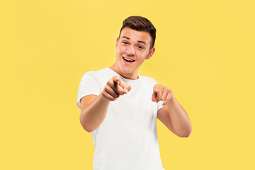 Image showing Caucasian young man\'s half-length portrait on yellow background