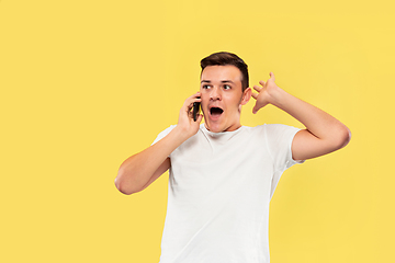 Image showing Caucasian young man\'s half-length portrait on yellow background