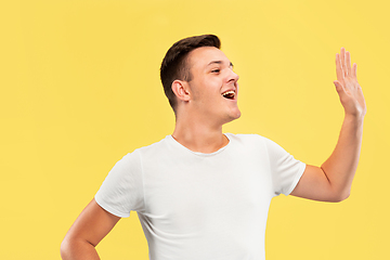 Image showing Caucasian young man\'s half-length portrait on yellow background