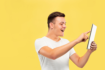 Image showing Caucasian young man\'s half-length portrait on yellow background