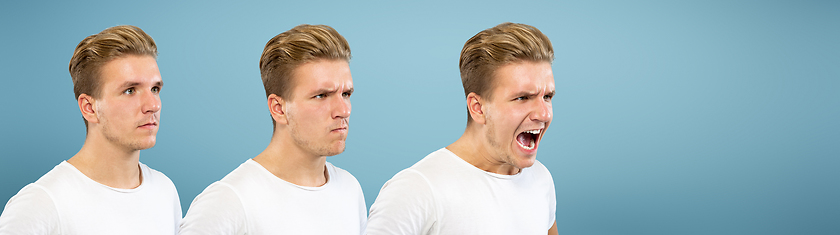 Image showing Caucasian young man\'s close up portrait on blue background