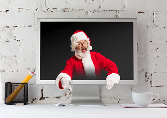 Image showing Happy Christmas Santa Claus with monitor