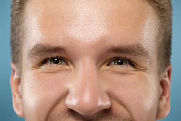 Image showing Caucasian young man\'s close up portrait on blue background