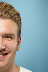 Image showing Caucasian young man\'s close up portrait on blue background