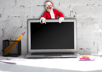 Image showing Happy Christmas Santa Claus with laptop
