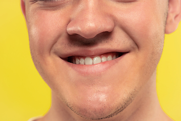 Image showing Caucasian young man\'s close up portrait on yellow background