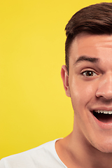 Image showing Caucasian young man\'s close up portrait on yellow background