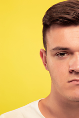 Image showing Caucasian young man\'s close up portrait on yellow background