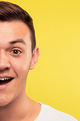 Image showing Caucasian young man\'s close up portrait on yellow background