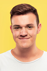 Image showing Caucasian young man\'s close up portrait on yellow background