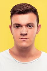 Image showing Caucasian young man\'s close up portrait on yellow background