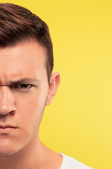 Image showing Caucasian young man\'s close up portrait on yellow background