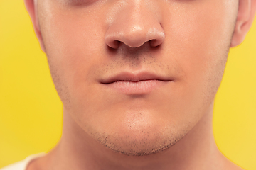 Image showing Caucasian young man\'s close up portrait on yellow background