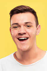 Image showing Caucasian young man\'s close up portrait on yellow background