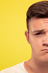 Image showing Caucasian young man\'s close up portrait on yellow background