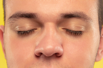 Image showing Caucasian young man\'s close up portrait on yellow background