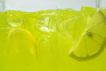 Image showing Close up view of the lemon slices in lemonade on background