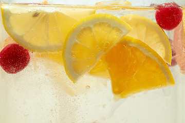 Image showing Close up view of the lemon slices in lemonade on background