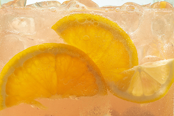 Image showing Close up view of the lemon slices in lemonade on background