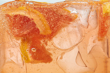 Image showing Close up view of the lemon and grapefruit slices in lemonade on background