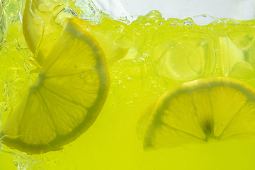 Image showing Close up view of the lemon slices in lemonade on background