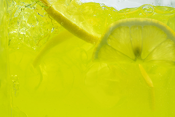 Image showing Close up view of the lemon slices in lemonade on background