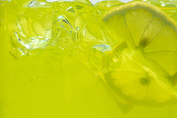 Image showing Close up view of the lemon slices in lemonade on background