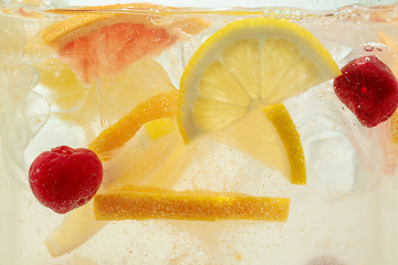 Image showing Close up view of the lemon slices in lemonade on background