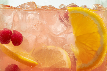 Image showing Close up view of the lemon slices in lemonade on background