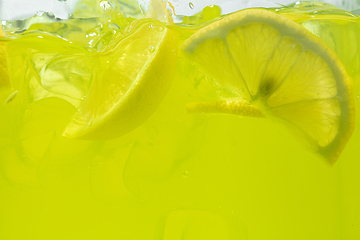 Image showing Close up view of the lemon slices in lemonade on background