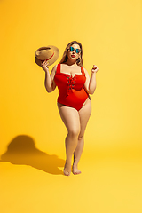 Image showing Young caucasian plus size female model\'s preparing for beach resort