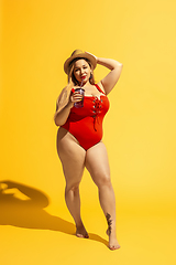 Image showing Young caucasian plus size female model\'s preparing for beach resort