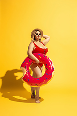 Image showing Young caucasian plus size female model\'s preparing for beach resort