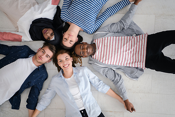 Image showing top view of a diverse group of people lying on the floor and symbolizing togetherness