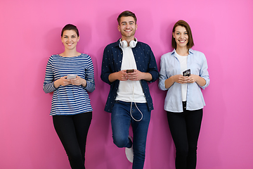 Image showing group of friends have fun and dance while using a cell phone and headphones