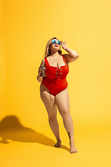 Image showing Young caucasian plus size female model\'s preparing for beach resort