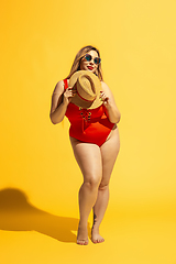 Image showing Young caucasian plus size female model\'s preparing for beach resort