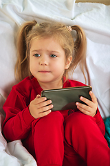 Image showing Little girl in soft warm pajama playing at home