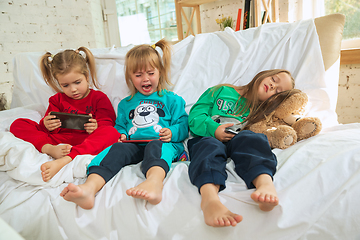 Image showing Little girls in soft warm pajamas playing at home