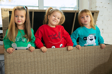 Image showing Little girls in soft warm pajamas playing at home