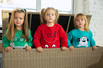 Image showing Little girls in soft warm pajamas playing at home