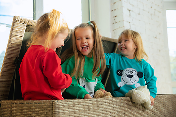 Image showing Little girls in soft warm pajamas playing at home