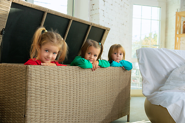 Image showing Little girls in soft warm pajamas playing at home