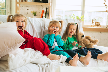 Image showing Little girls in soft warm pajamas playing at home