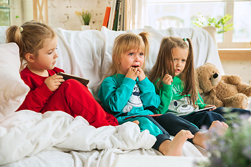 Image showing Little girls in soft warm pajamas playing at home