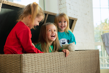 Image showing Little girls in soft warm pajamas playing at home