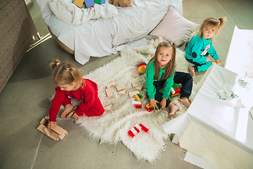 Image showing Little girls in soft warm pajamas playing at home