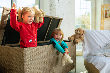 Image showing Little girls in soft warm pajamas playing at home